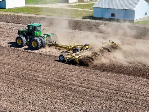 Thomson, Illinois, April 24, 2026, John Deere 9560R tractor pulling a Degelman Pro-Till 36 heavy-duty rotary tillage/soil cuktivator