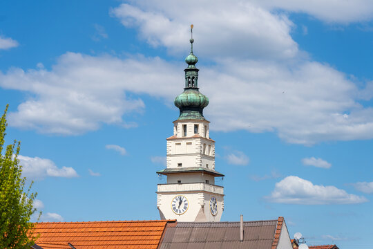 The tower of the town hall stands tall against a clear blue sky in Boskovice, Czechia. The architecture reflects local history and culture, as it overlooks the town's streets.