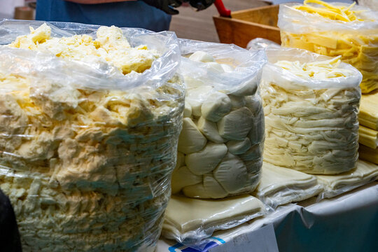 Various Turkish cheese on in diary production market. A lot of kind Turkish cheese  wheels on the shelves in diary production market. Food. Organic fresh chee se  skin and blocks of raw  in stainless 