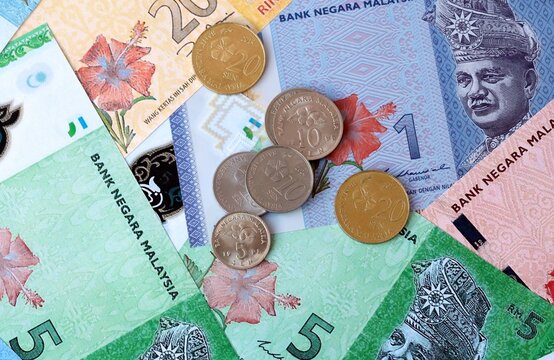 Malaysian ringgit money banknotes and coins on table. Malaysia cash bills of MYR currency