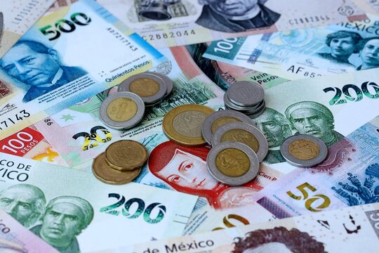 Mexican peso money banknotes and coins on table. Mexico cash bills of MXN currency