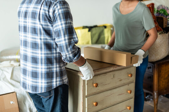 Couple moving furniture together photo