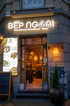 Cologne, Germany May 23 2026: Cozy facade of Bep Ngoai restaurant on Venloer Strasse in Cologne at dusk, featuring glowing signs and warm lights