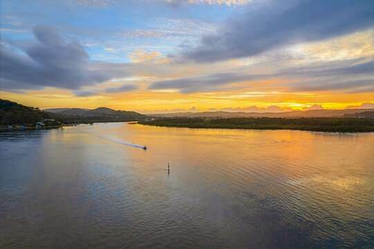Sunrise waterscape with a mix of low, medium and high clouds