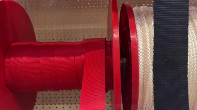 Close-up of colorful sewing fabric thread spools on retail shop shelves