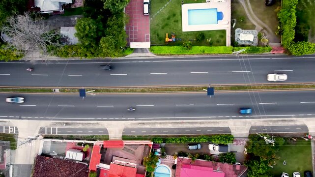 Aerial Top view road Armenia- Tebaida, Quindio cars and bicycle street, trees and grass