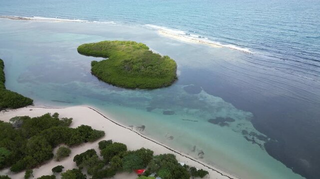 Aerial panorama of La Cobita natural landscape with small tropical islands, calm shallow sea, white sand and vibrant blue-green Caribbean water.