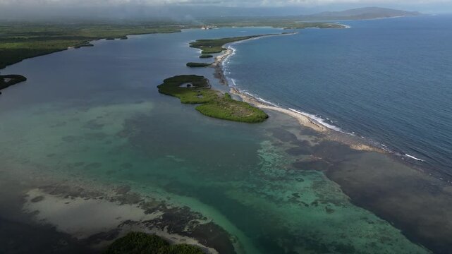 Drone footage of La Cobita lagoon with tropical mangroves, transparent shallow water, white sand beach and peaceful Caribbean coastline in sunny weather