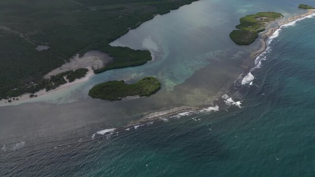 Wide drone panorama of tropical islands and calm Caribbean sea at La Cobita Beach featuring turquoise water and untouched natural scenery.