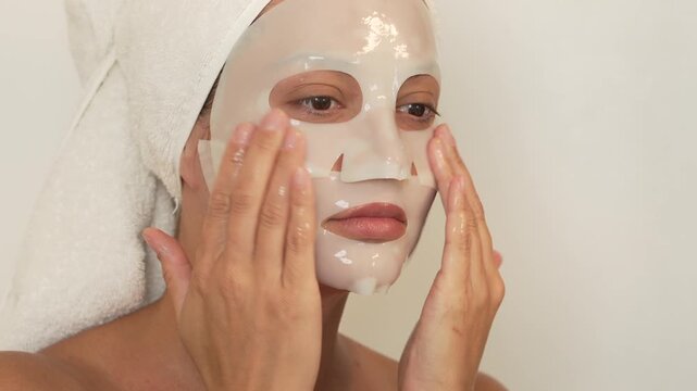 Young domestic woman posing apply  face mask for skin care