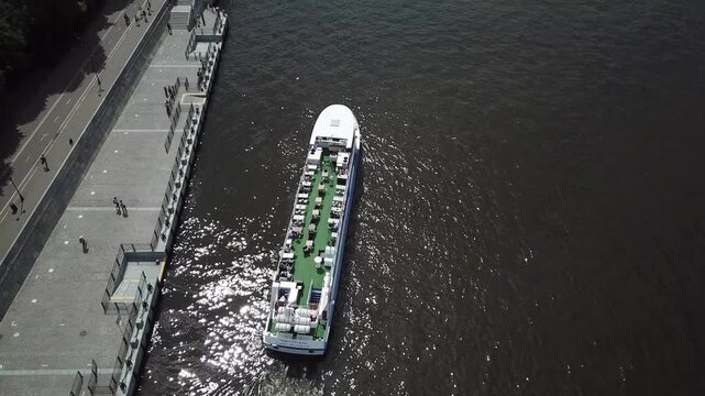Smooth drone upward tilt over Moscow riverboat