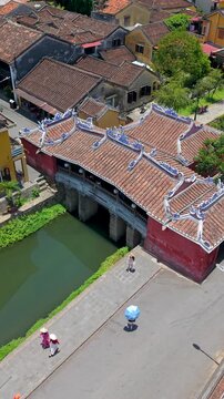 Aerial view of Chua Cau or Japanese Covered ancient Bridge and River in Old city of Hoi An, Vietnam. One of the most travel popular touristic destinations, UNESCO world heritage 
