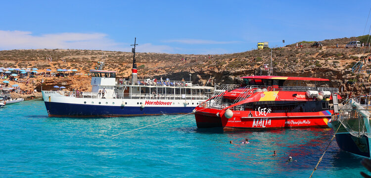 COMINO MALTA: Beautiful blue lagoon with turquoise clear water, yachts and boats on a sunny summer day. Comino, Malta