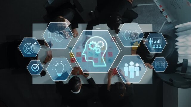 Aerial view of a business meeting where professionals engage in strategic discussions, supported by digital icons representing technology and data analysis. Raster