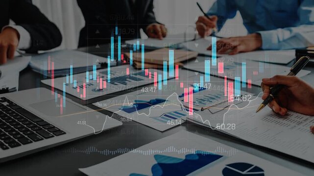 A collaborative business meeting where a professional team analyzes financial data using charts and graphs displayed on a table, emphasizing strategic decision-making. Raster