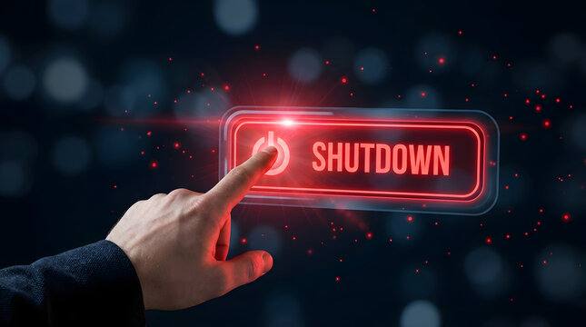 Hand pressing shutdown button with glowing red light on dark background with bokeh effect