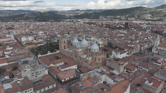 Aerial Drone View of Parque Calder&oacute;n and New Cathedral in Cuenca Ecuador &ndash; Historic City Center. Aerial view featuring colonial architecture, blue domes of the cathedral, surrounding plazas.