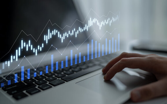A professional workspace featuring a laptop displaying data analysis with graphs and charts, highlighting trends and growth for financial success. Scalp