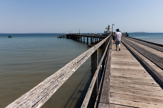 weathered wooden jetty at Kingfisher Bay on a sunny day
