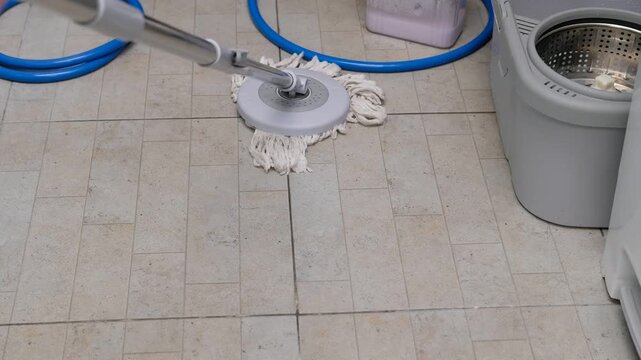  Close up of mop cleaning dirty floor surface, cleanliness and housekeeping background idea