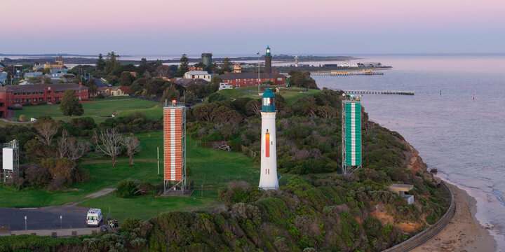 Aerial panorama of lighthouses and signal towers on a coastal cliff top at twilight