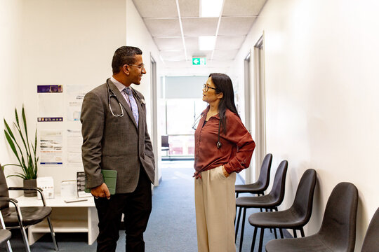 Doctors conversing in clinic hallway