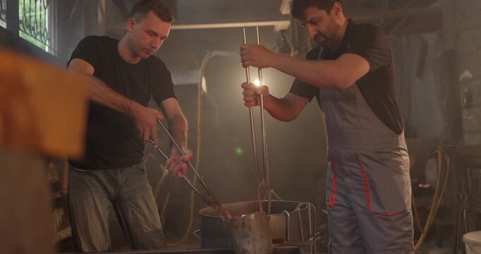 Foundry Workers Pouring Molten Metal in Traditional Casting Workshop