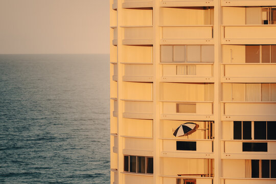 Open beach umbrella on balcony of seaside apartment building on the Gold Coast
