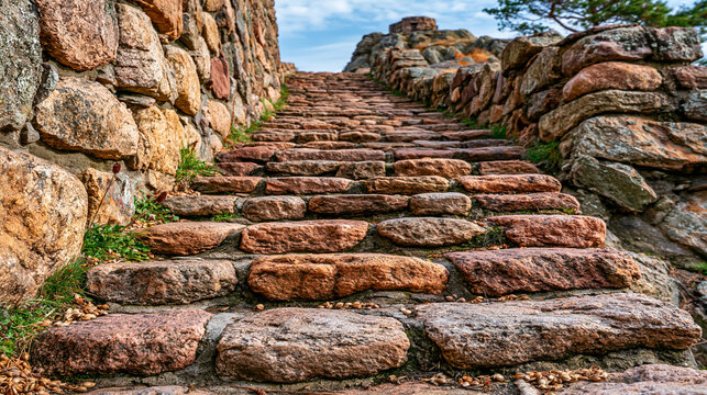 Ancient stone staircase ascending rugged cliff side with staircase climbing architecture