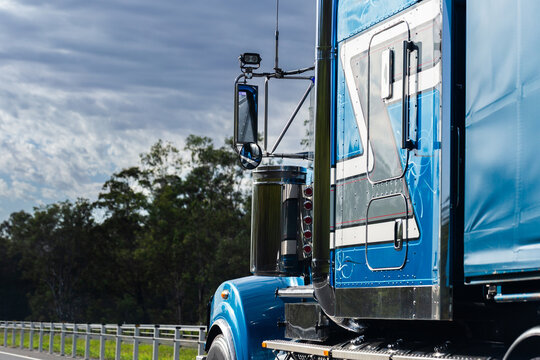 Blue truck traveling on highway road transporting goods in Australia