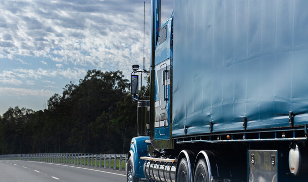 Blue truck traveling on highway road transporting goods in Australia