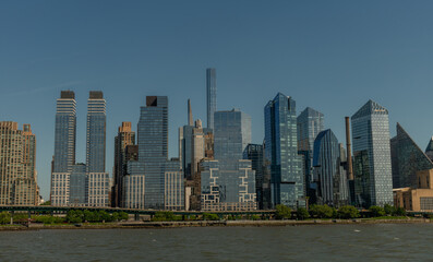 Fototapeta premium Scenic panoramic Upper West Side shore vista on a sunny summer day viewed from a boat, New York City 