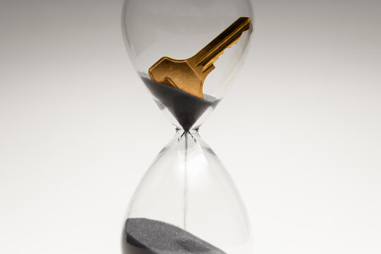 Key inside hourglass, limited time, life opportunities and time management
