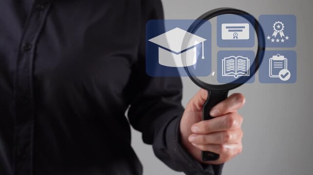 Close-up of a woman's hand with a magnifying glass analyzing an animation of an academic interface. Graduation cap icons represent achievement and culmination.