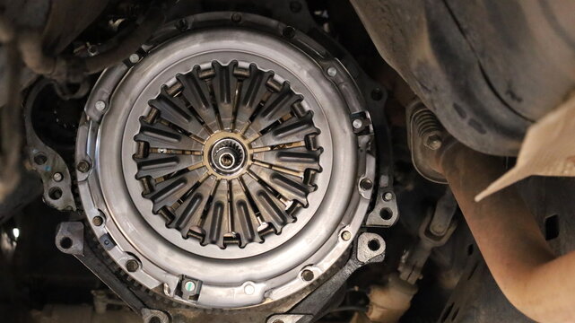 Installation of a new clutch kit. Close-up of a replacement clutch kit for a pickup truck in an auto repair shop. Car maintenance concept with focus selection.