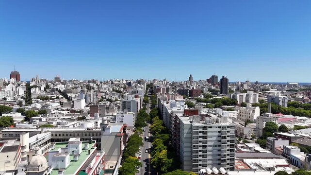 PUNTA DEL ESTE, URUGUAY: High-angle drone view of the urban skyline featuring Torre El Torreon, luxury high-rise apartments, green roundabouts, and the ocean horizon under a cloudy sky.