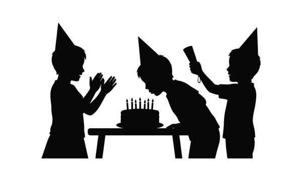 Silhouette of children wearing party hats celebrating a birthday with a cake on a table.