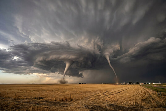 Two massive tornados descending from a dark supercell
