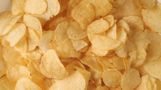 Potato chips rotating creating a food background