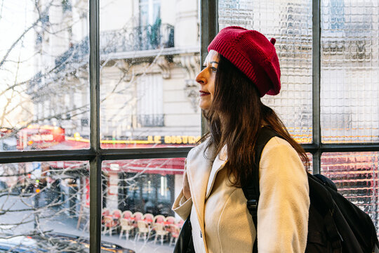 Woman wearing red beret traveling solo in paris
