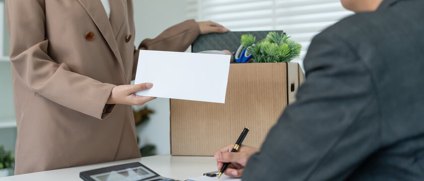 resignation, leave, quit, employee pass on resignation letter to Business owner . staff is lifting a brown paper box that holds personal items. , job placement and vacancies, resignation letter
