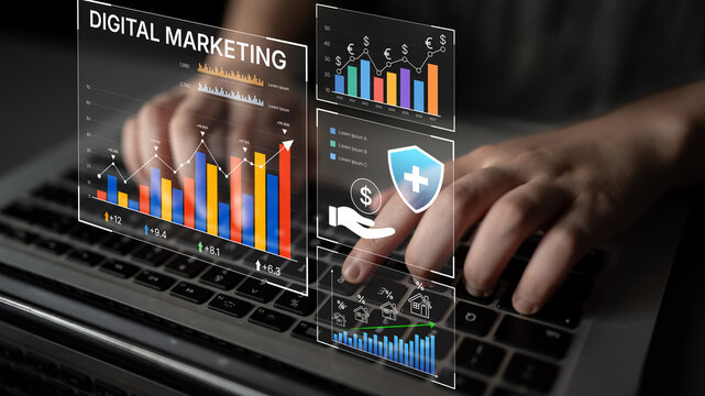 Hands Typing on Laptop with Overlaid Digital Marketing Graphics and Data Visualizations in a Modern Business Environment. Bitwise.