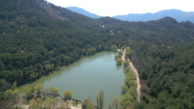 Aerial View of Karagol Lake Surrounded by Dense Green Pine Forest in Izmir Turkey. High quality 4k footage