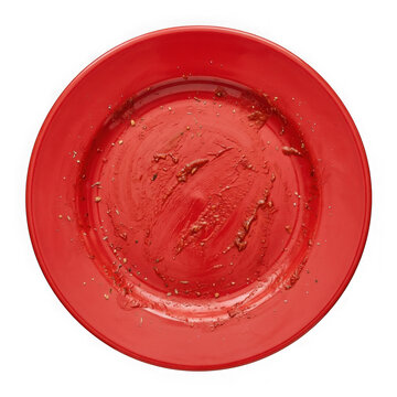 Used red plate showing leftover food residue