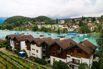 Fototapeta premium Bern Switzerland Lakeside Village with Sailboats and Alpine Mountains