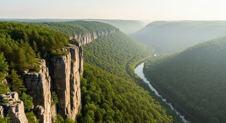 Obraz premium Steep Rocky Cliffs Overlooking Lush Green Valley and Winding River
