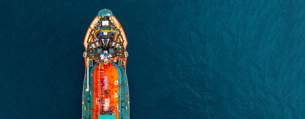 Aerial view Gas ship tanker vessel loading and unloading in oil terminal station refinery, Global business import export logistic transport sea freight cargo gas tanker ship, Gas tanker ship at sea. © Kalyakan