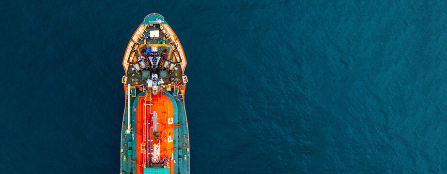 Aerial view Gas ship tanker vessel loading and unloading in oil terminal station refinery, Global business import export logistic transport sea freight cargo gas tanker ship, Gas tanker ship at sea.