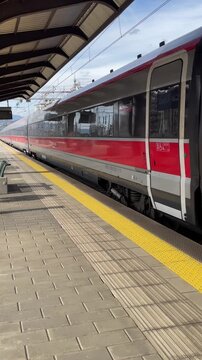 Italy , Florence, March 31st 2026- Vertical video Frecciarossa Trenitalia Hight speed 300km h train railway view from a station the faster way to travel in Italy from Milan to Rome. A1 motorway , cars