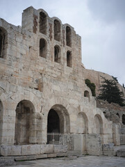 Naklejka premium Greece, Athens. Ancient stone building facade with arched windows, historic architecture, cultural heritage, old ruins, travel destination.